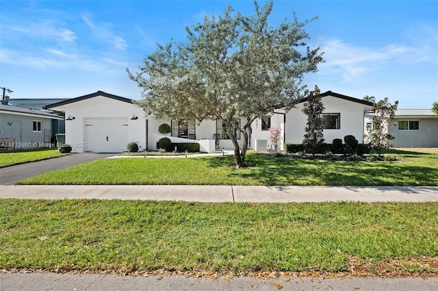 view of front of home featuring a garage and a front lawn