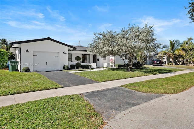 view of front of property with a front lawn and a garage