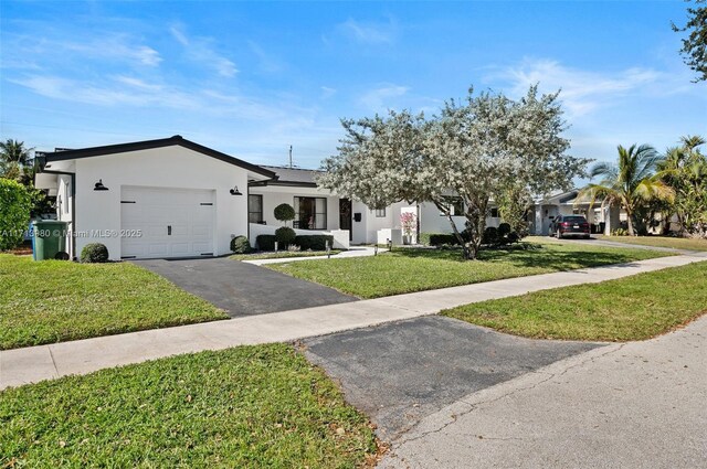 view of front of property with a front lawn and a garage