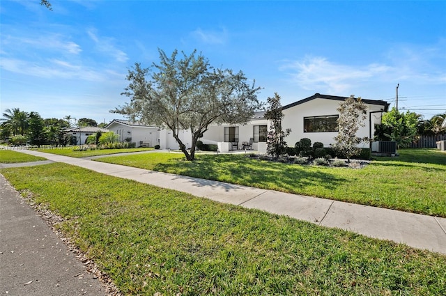 view of front facade with a front yard and cooling unit