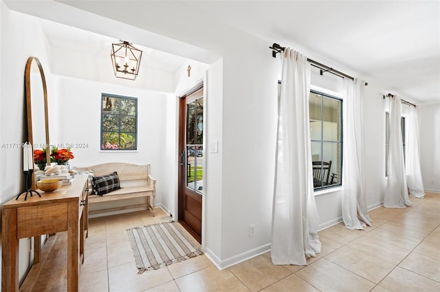 interior space featuring light tile patterned flooring and a notable chandelier