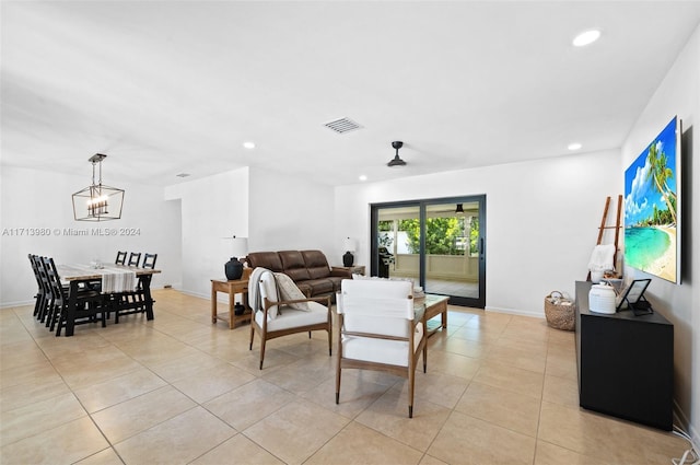 living room with ceiling fan with notable chandelier and light tile patterned flooring