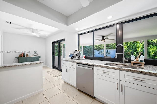 kitchen featuring light stone countertops, dishwasher, sink, and white cabinetry