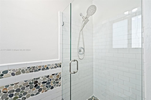 bathroom with a shower with door