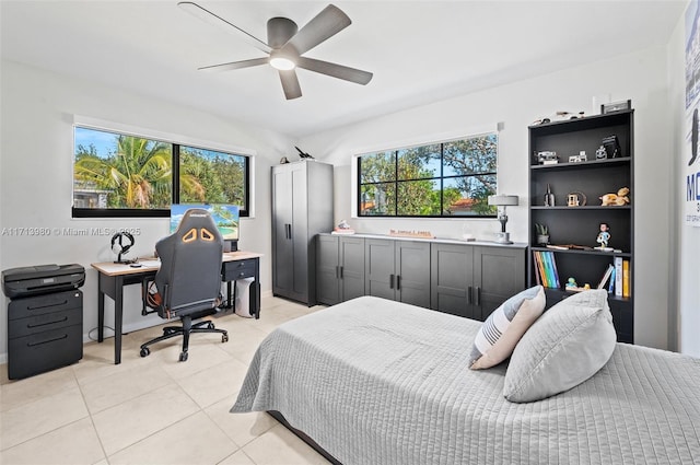 bedroom with ceiling fan, light tile patterned flooring, and multiple windows