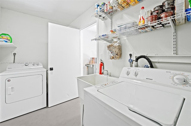 clothes washing area with sink and washing machine and dryer