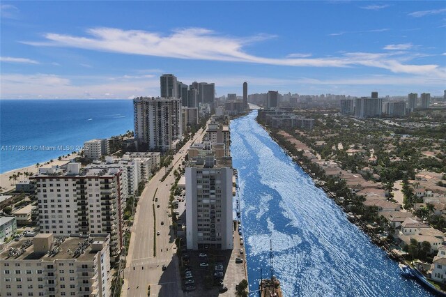 drone / aerial view with a water view and a beach view