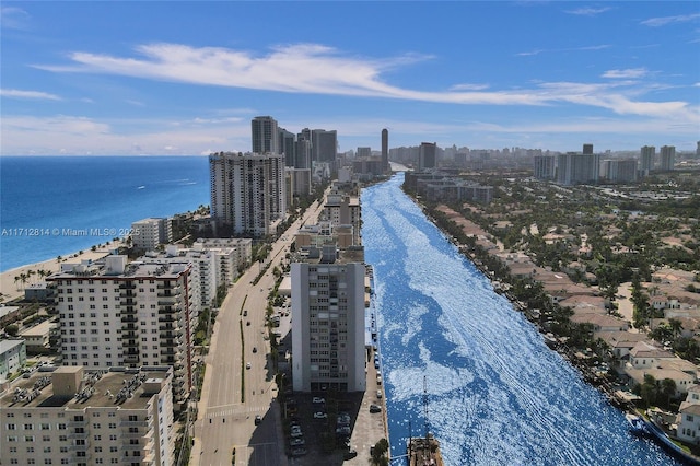 birds eye view of property with a view of the beach and a water view