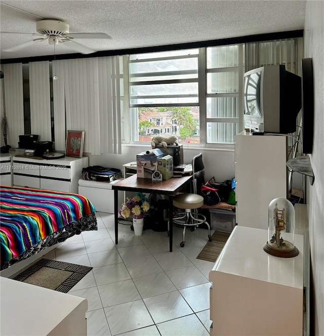 bedroom featuring light tile patterned floors, a textured ceiling, and ceiling fan