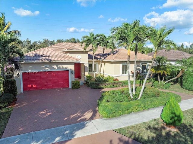 mediterranean / spanish-style house with a garage