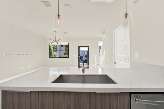 kitchen with a chandelier, dishwasher, pendant lighting, and dark brown cabinets