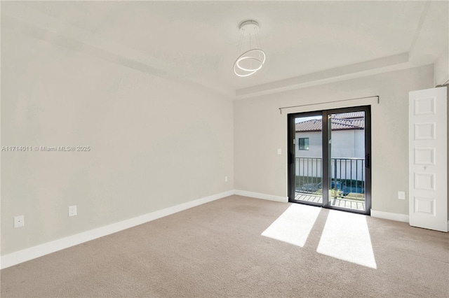 spare room featuring light colored carpet