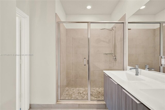 bathroom featuring tile patterned flooring, vanity, and an enclosed shower