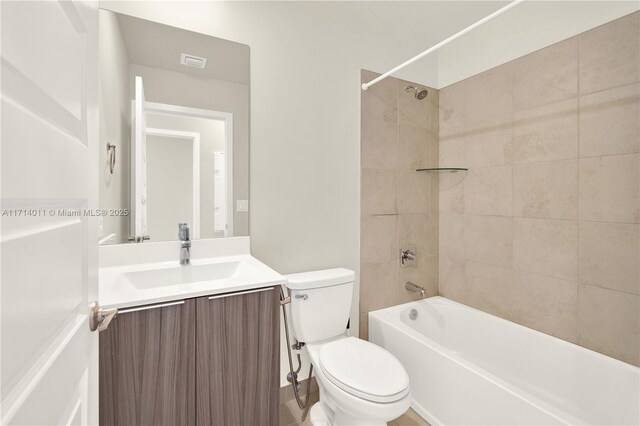 full bathroom with vanity, toilet, and tiled shower / bath