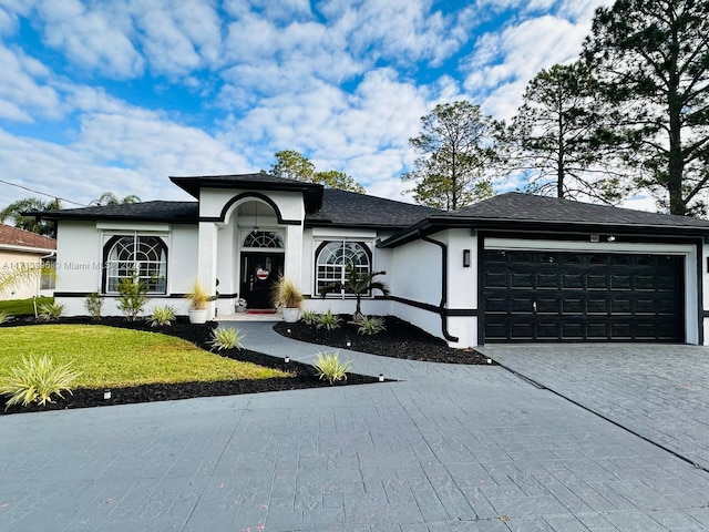 view of front of house with a front yard and a garage