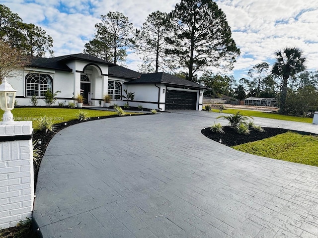 view of front of home featuring a front lawn and a garage