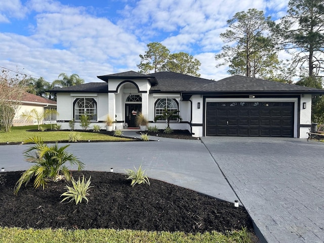 view of front facade featuring a front yard and a garage