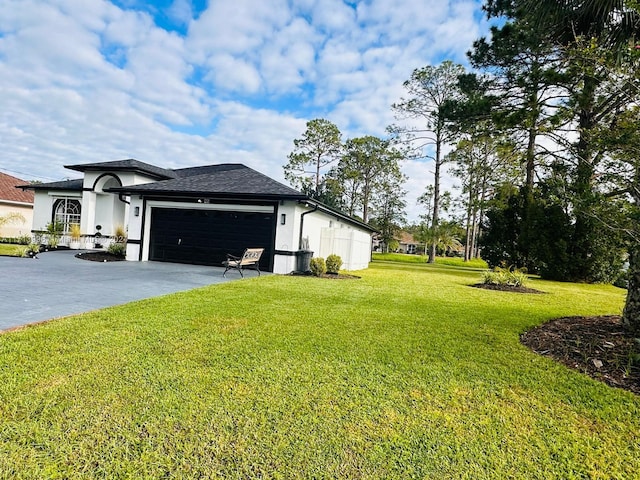 view of home's exterior with a yard and a garage