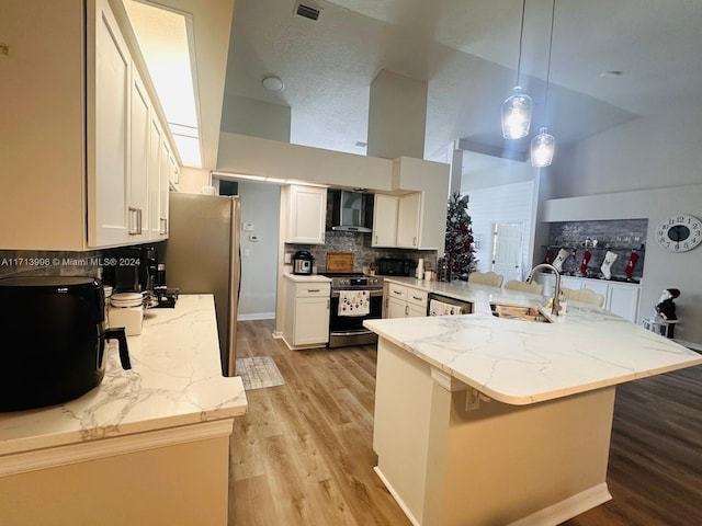 kitchen with pendant lighting, white cabinetry, kitchen peninsula, and stainless steel appliances