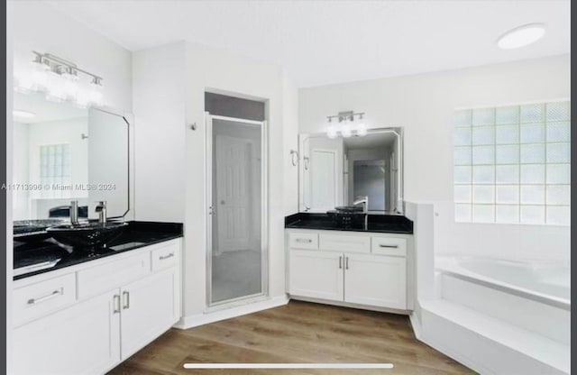 bathroom featuring separate shower and tub, vanity, and wood-type flooring