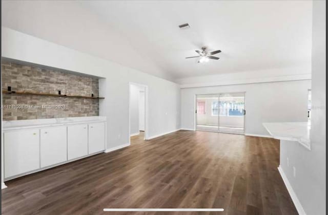 unfurnished living room featuring ceiling fan and dark wood-type flooring