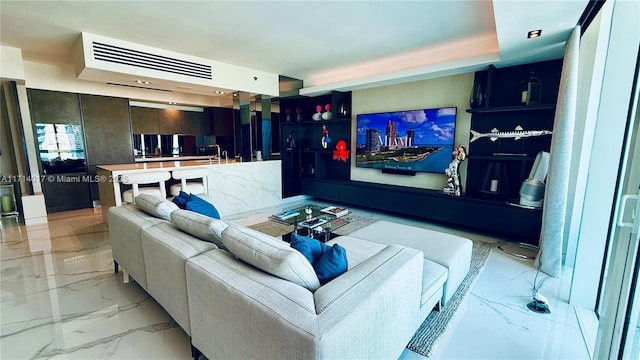 living room featuring a tray ceiling