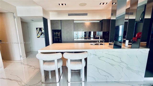 kitchen featuring sink and a breakfast bar area