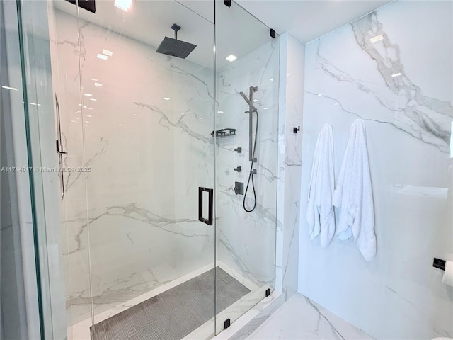 bathroom with a shower with shower door