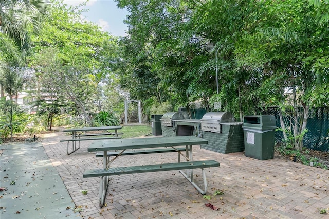 view of community featuring a patio and an outdoor kitchen