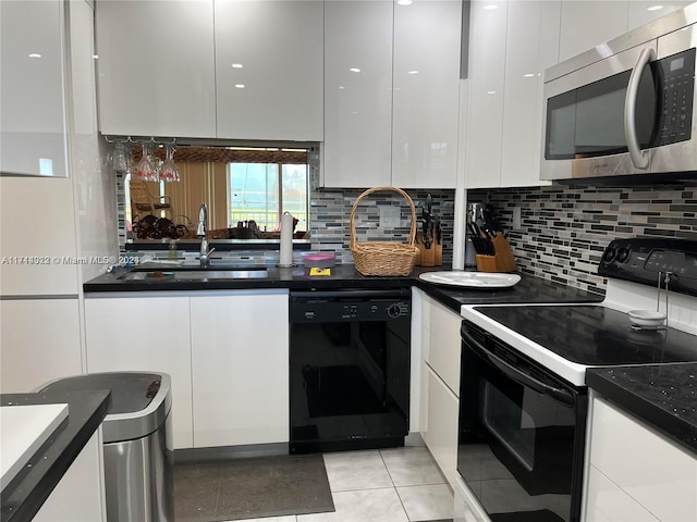 kitchen featuring light tile patterned floors, sink, white cabinetry, and black appliances