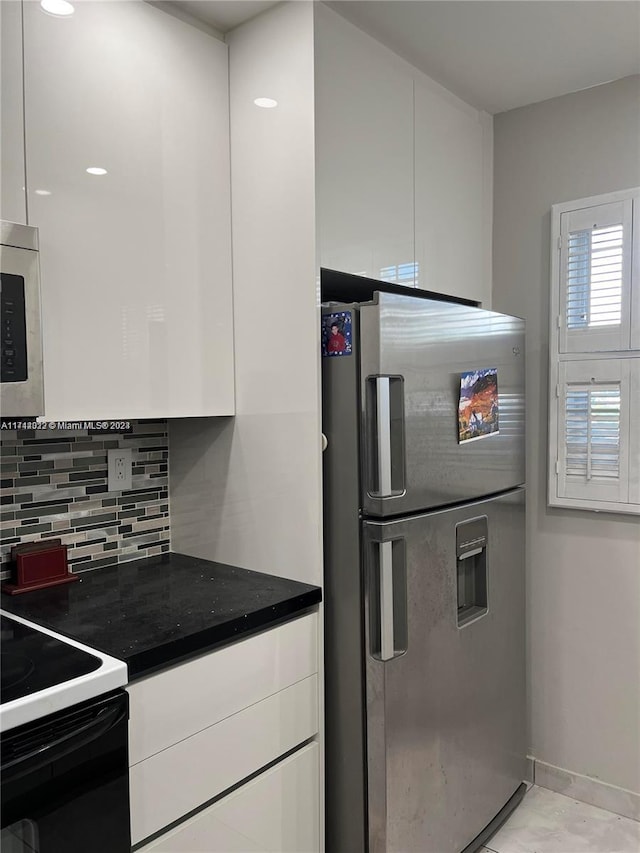 kitchen featuring tasteful backsplash, white cabinetry, and appliances with stainless steel finishes