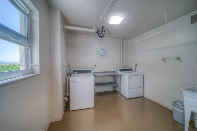 clothes washing area featuring separate washer and dryer