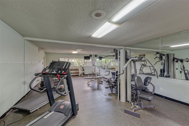 gym featuring a textured ceiling