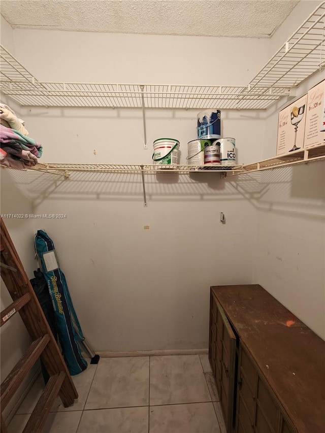 spacious closet with light tile patterned floors