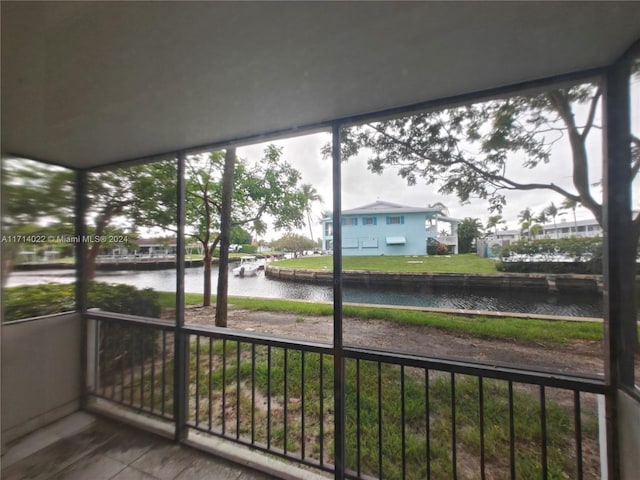 unfurnished sunroom with a healthy amount of sunlight and a water view