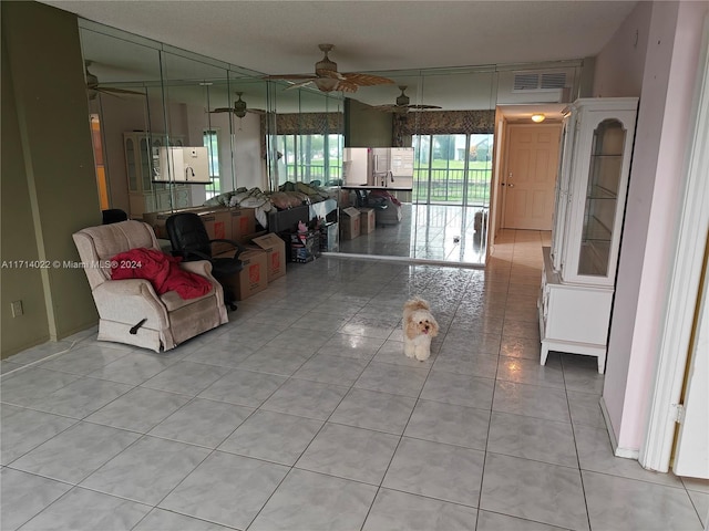 living room with light tile patterned floors and ceiling fan