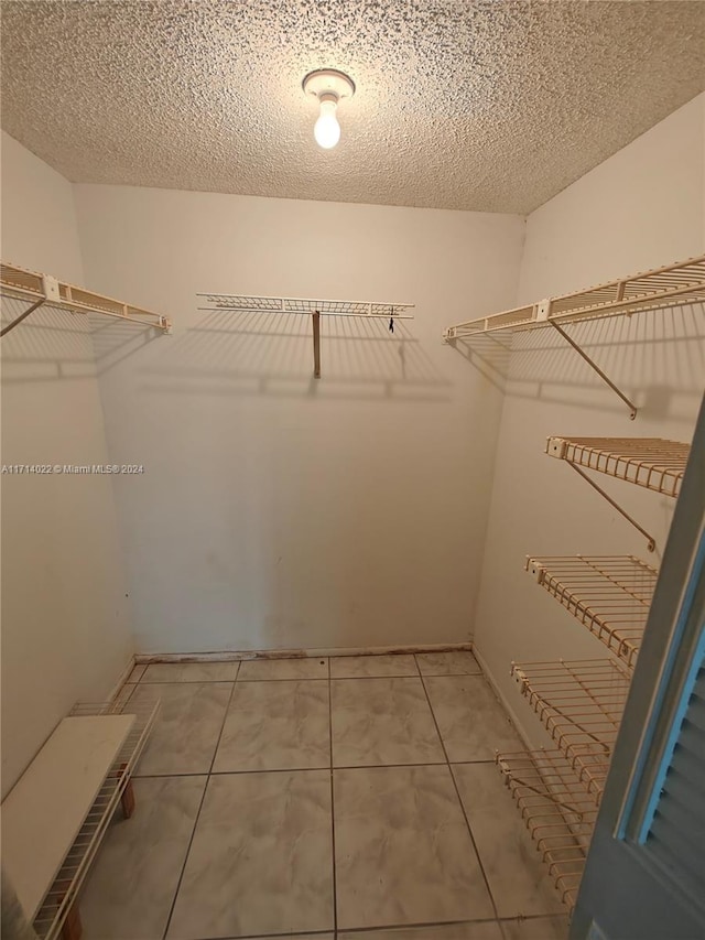 walk in closet featuring tile patterned flooring