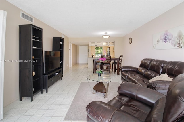 living room with tile patterned flooring and a textured ceiling