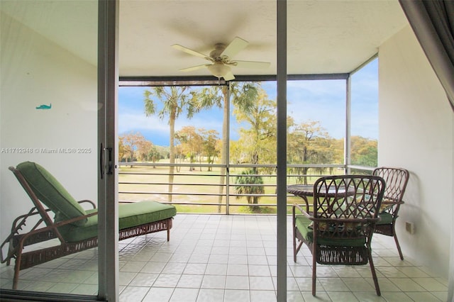 sunroom / solarium with a ceiling fan and healthy amount of natural light