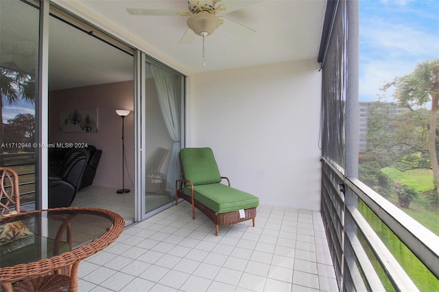 sunroom / solarium featuring ceiling fan