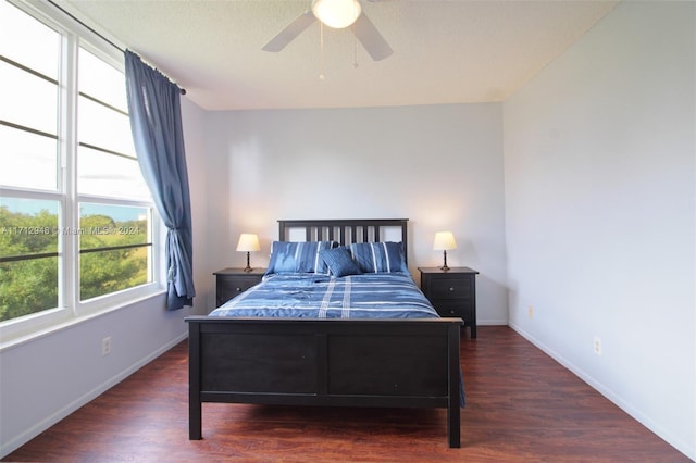 bedroom with ceiling fan and dark wood-type flooring