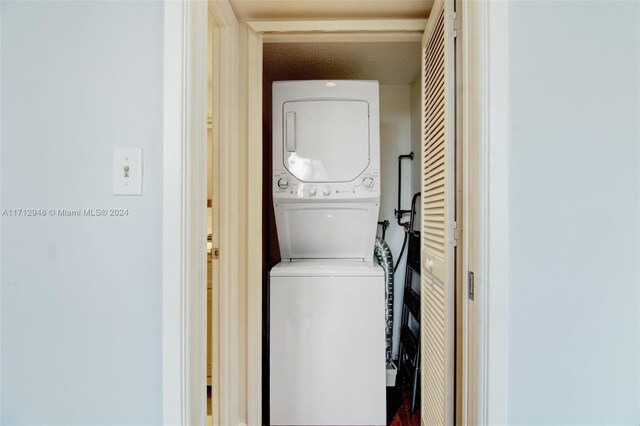 washroom featuring stacked washer and dryer