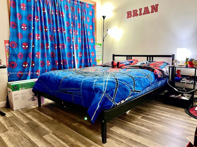 bedroom with wood finished floors