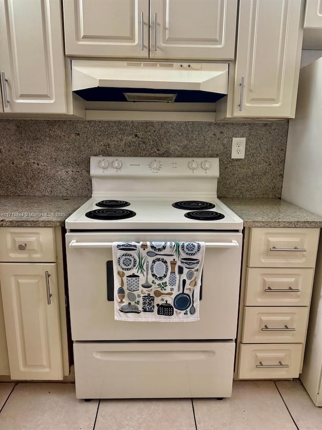 kitchen featuring light tile patterned floors, electric stove, under cabinet range hood, white cabinetry, and backsplash