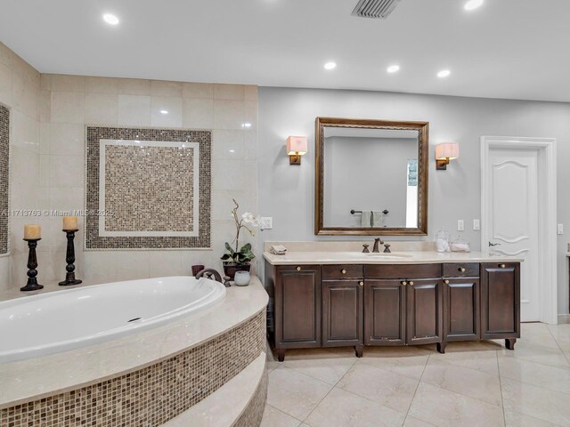 bathroom with tile patterned floors, vanity, and shower with separate bathtub