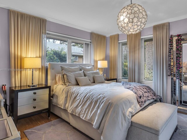 bedroom featuring dark hardwood / wood-style floors and crown molding