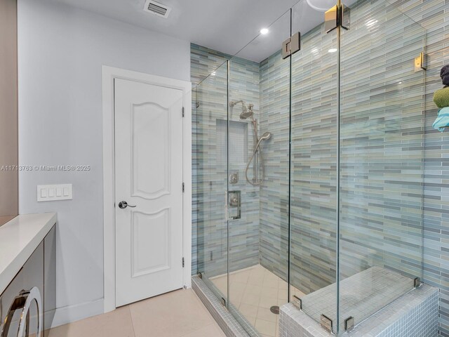 bathroom with tile patterned floors and a shower with shower door