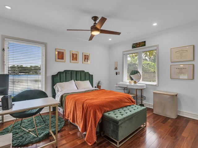 bedroom with ceiling fan, crown molding, and dark wood-type flooring