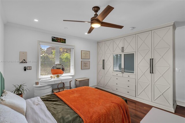 bedroom featuring ceiling fan, dark hardwood / wood-style flooring, and ornamental molding