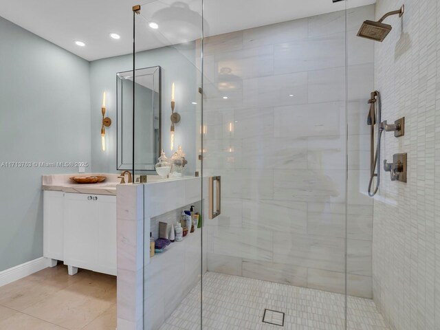 bathroom with tile patterned floors, vanity, and an enclosed shower